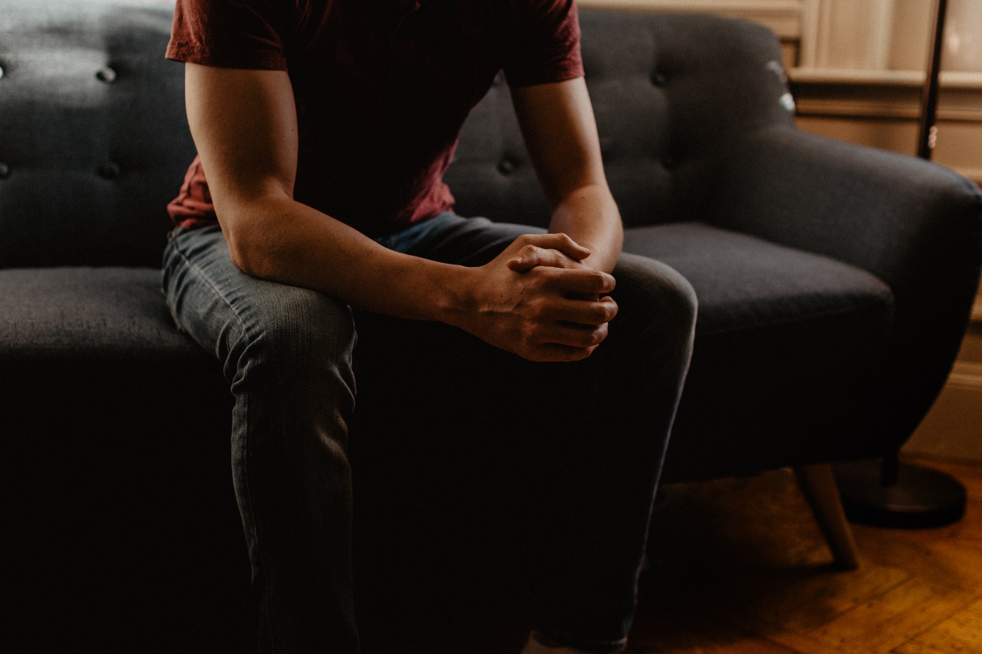 Teenage client, sitting on couch, suffering from social anxiety.